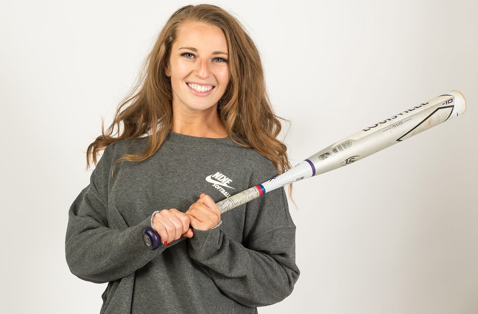 girl holding a bat in a posed photo
